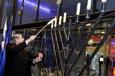 President of Slovenia Dr Danilo Türk lights a candle on Jewish candelabrum Hanukkiyah at the Hanukkah 5772 ceremony (photo: Stanko Gruden/STA)
